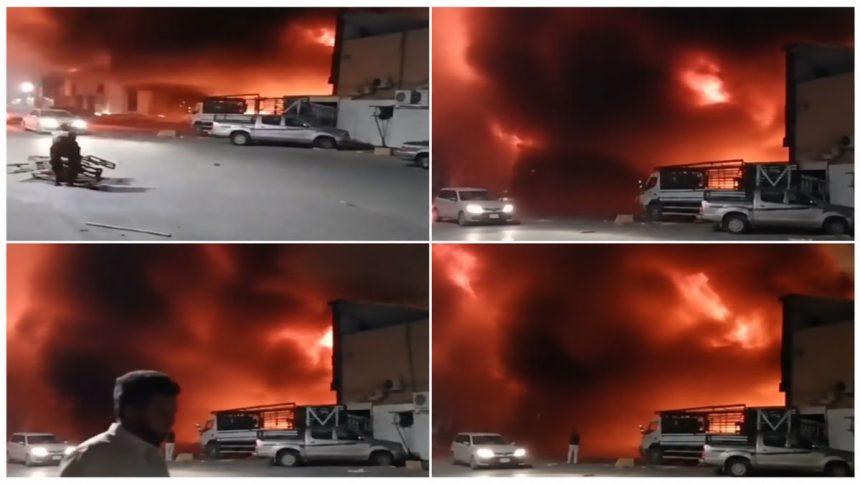 Large fire and heavy smoke after the Najran Houthi attack in Saudi Arabia, with vehicles and buildings near the affected area.