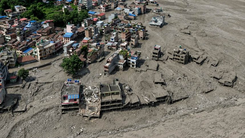 Rescuers carry a flood survivor in Devghat Nepal