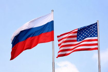 The national flags of Russia and the United States are displayed together, symbolizing diplomatic relations and international engagement.