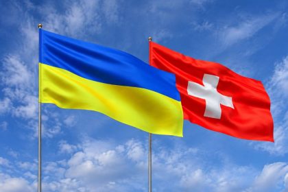 Ukraine and Switzerland flags waving side by side