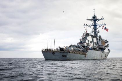 USS Benfold warship sailing through the open sea under cloudy skies