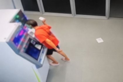 Person near an ATM during a reported West Bank smashing spree.