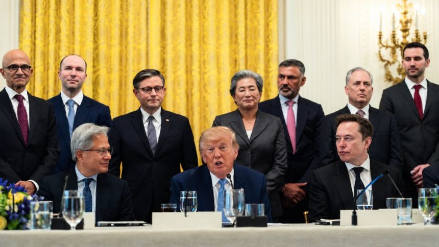 President Donald Trump seated with technology executives during a White House meeting.