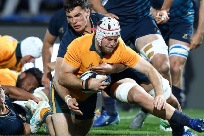 Australia and Argentina players compete for possession during a physical rugby match.