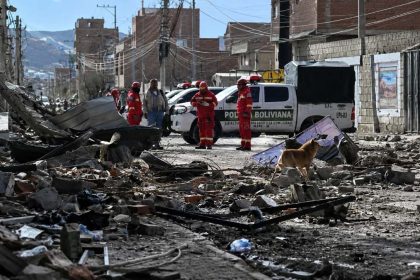 Aftermath of a blast at a Bolivian army base, with emergency personnel inspecting the damaged area.