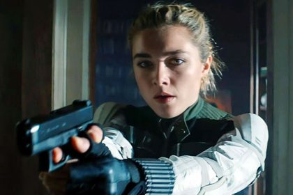 Florence Pugh with a handgun in a tense action scene.