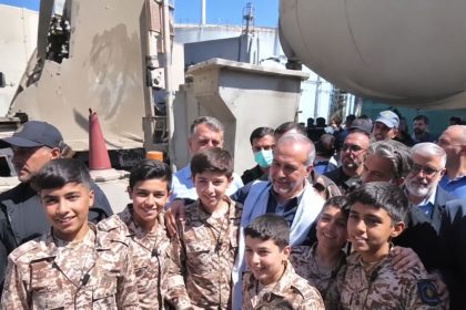 Masoud Pezeshkian with teenagers wearing Iranian military-style uniforms