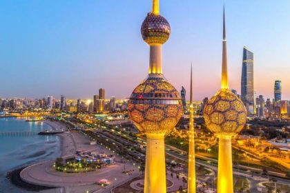 Kuwait Towers and Kuwait City skyline at dusk.