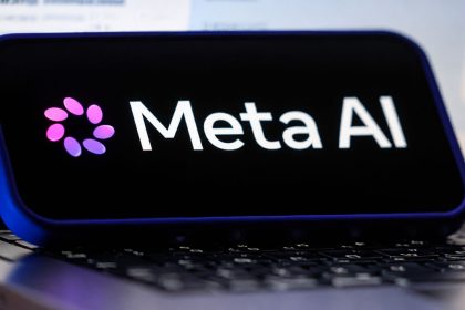 Meta AI logo displayed on a device above a laptop keyboard