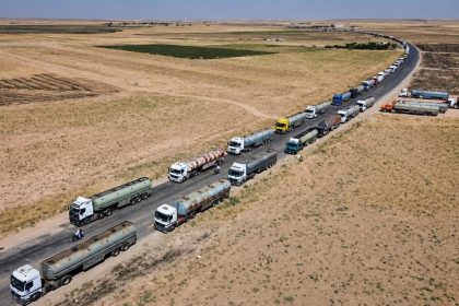Oil tankers from Iraq traveling along a road in a convoy to deliver fuel to Syria.