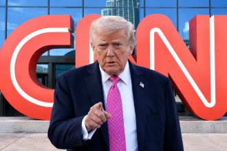 US President Donald Trump pictured with the CNN logo in the background