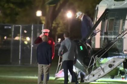 US President Donald Trump disembarks from a helicopter at Camp David
