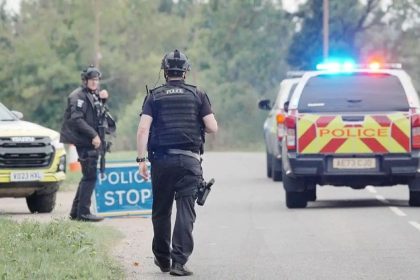 British police officers and police vehicles at a road checkpoint near RAF Fairford in Gloucestershire.