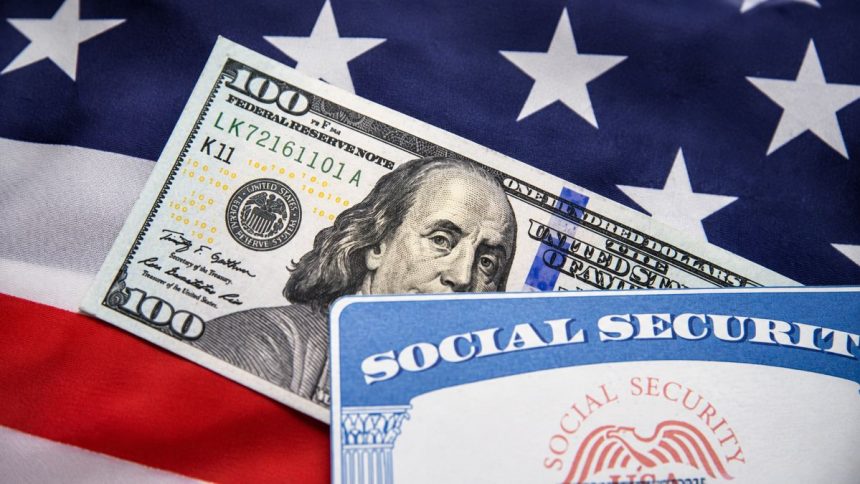 A $100 U.S. Federal Reserve note and Social Security card displayed against the American flag.