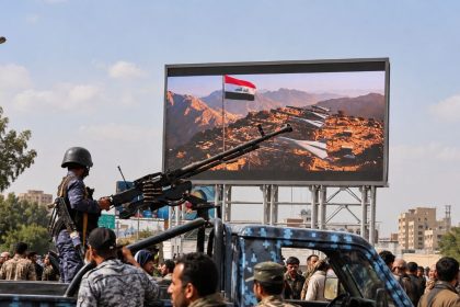 Houthi security member mans machine gun on patrol vehicle in Sanaa