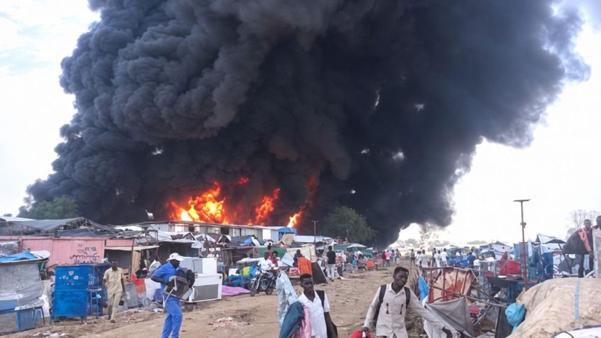 Thick black smoke rises above burning structures at Amiet Market in the disputed Abyei Area.