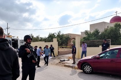 Security personnel and investigators at the scene outside Saint George’s Greek Orthodox Church in Jordan following a reported attack.