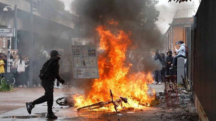 Students protest outside a school during demonstrations in France.
