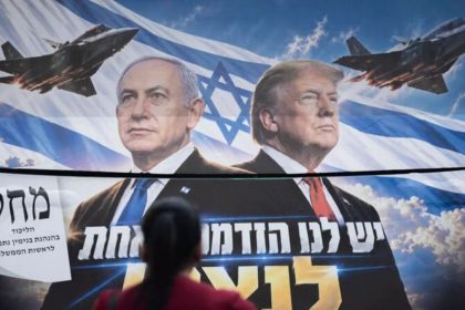 Benjamin Netanyahu and Donald Trump featured on an election campaign poster displayed on a bus in Jerusalem