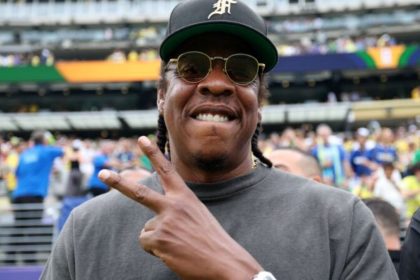 Jay-Z wearing a black cap and sunglasses at the Brazil vs Norway match during the 2026 FIFA World Cup.