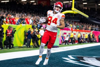 Kansas City Chiefs player Justin Watson wearing jersey number 84 and holding a football in the end zone.