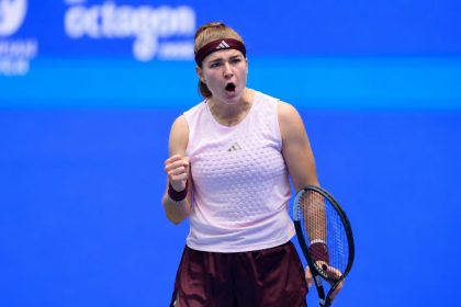 Karolína Muchová celebrates with a clenched fist and tennis racket during the 2026 Wuhan Open.