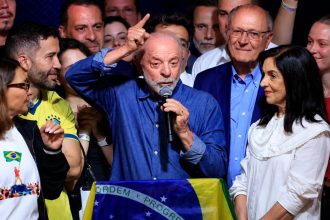 Brazilian President Luiz Inácio Lula da Silva speaking into a microphone at a political event.