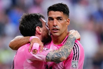 Lionel Messi and Luis Suárez hug in their pink Inter Miami jerseys after scoring two goals each against D.C. United.
