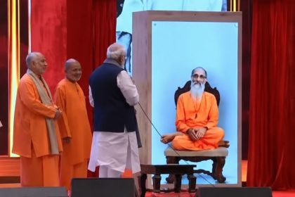 Narendra Modi interacting with a holographic representation of Swami Chinmayananda at Bharat Mandapam