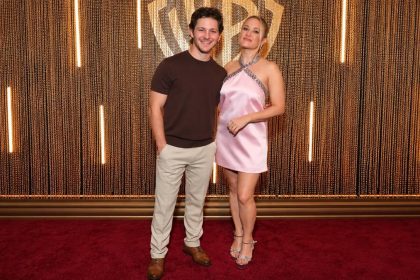 Montana Jordan and Emily Osment posing together on the red carpet.