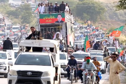 PTI supporters and vehicles travel in a large convoy during a long march in Khyber Pakhtunkhwa.