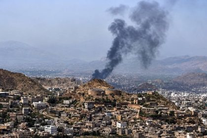 Thick smoke rises above buildings in Sana’a, Yemen, following reported airstrikes.