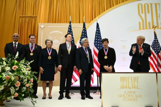 Donald Trump applauds as Satya Nadella, Michael Dell, Lisa Su, Elon Musk, Jensen Huang and Sergey Brin pose with their medals at a science and technology awards ceremony.