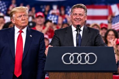 President Donald Trump standing beside Audi’s CEO at a rally in Perry, Georgia.