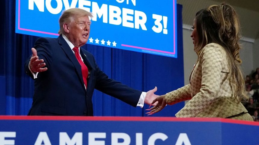 Donald Trump welcoming Nicki Minaj on stage at a Michigan rally.