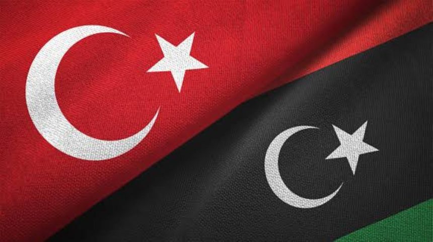Turkish and Libyan flags featuring white crescents and stars on red and black backgrounds.
