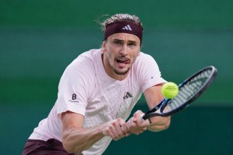 Alexander Zverev returns a tennis ball during his Shanghai Masters quarterfinal match against Alex de Minaur in China.